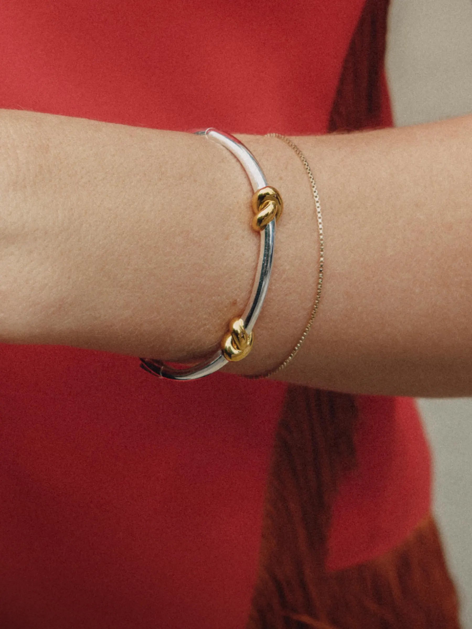 Gold chain bracelet on sweaty arm