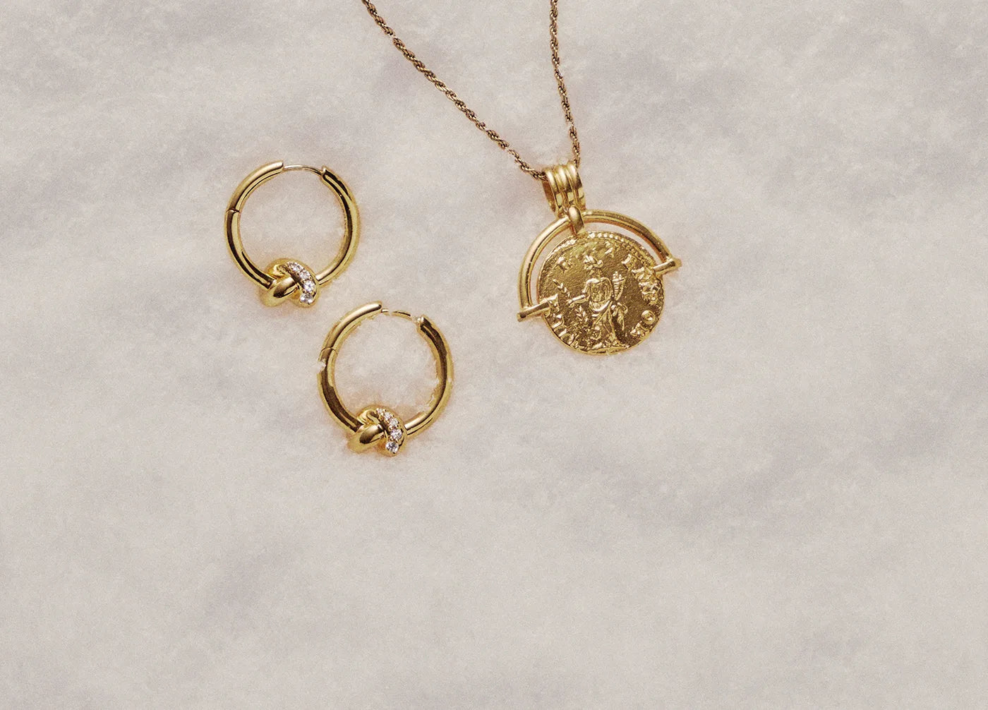 Gold hoop earrings and gold coin necklace