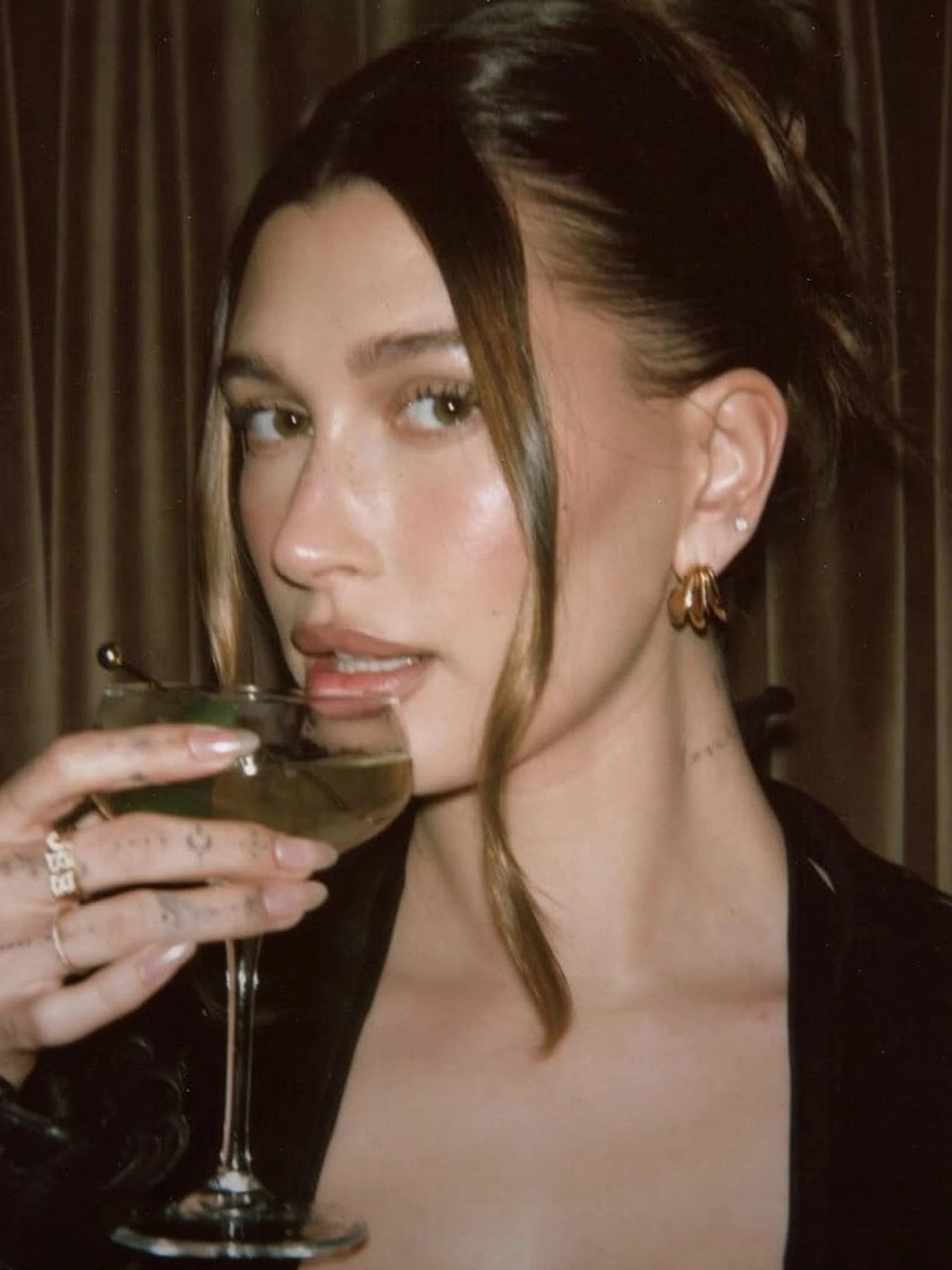 hailey bieber wearing gold earrings by missoma