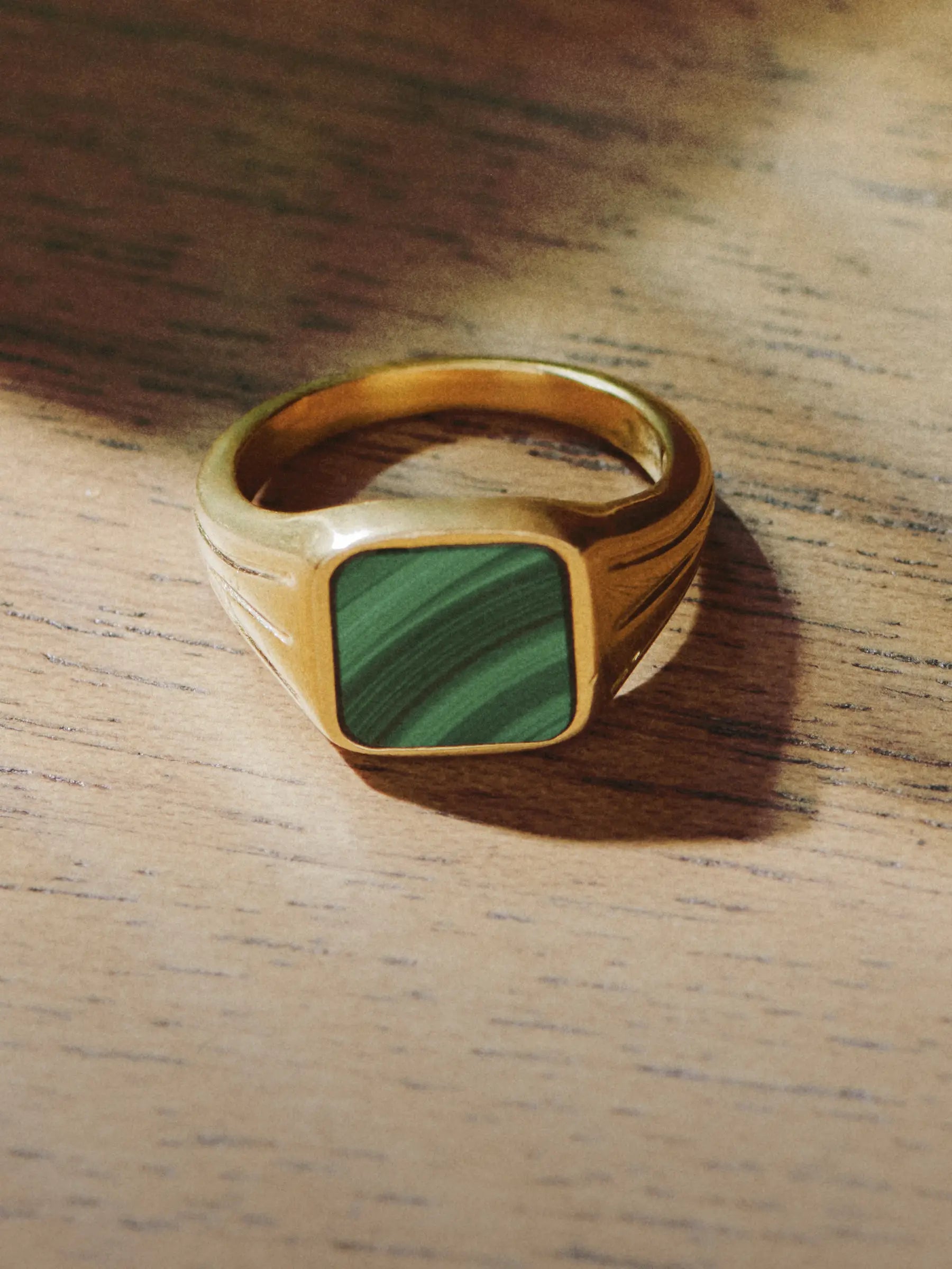gold signet ring with green stone