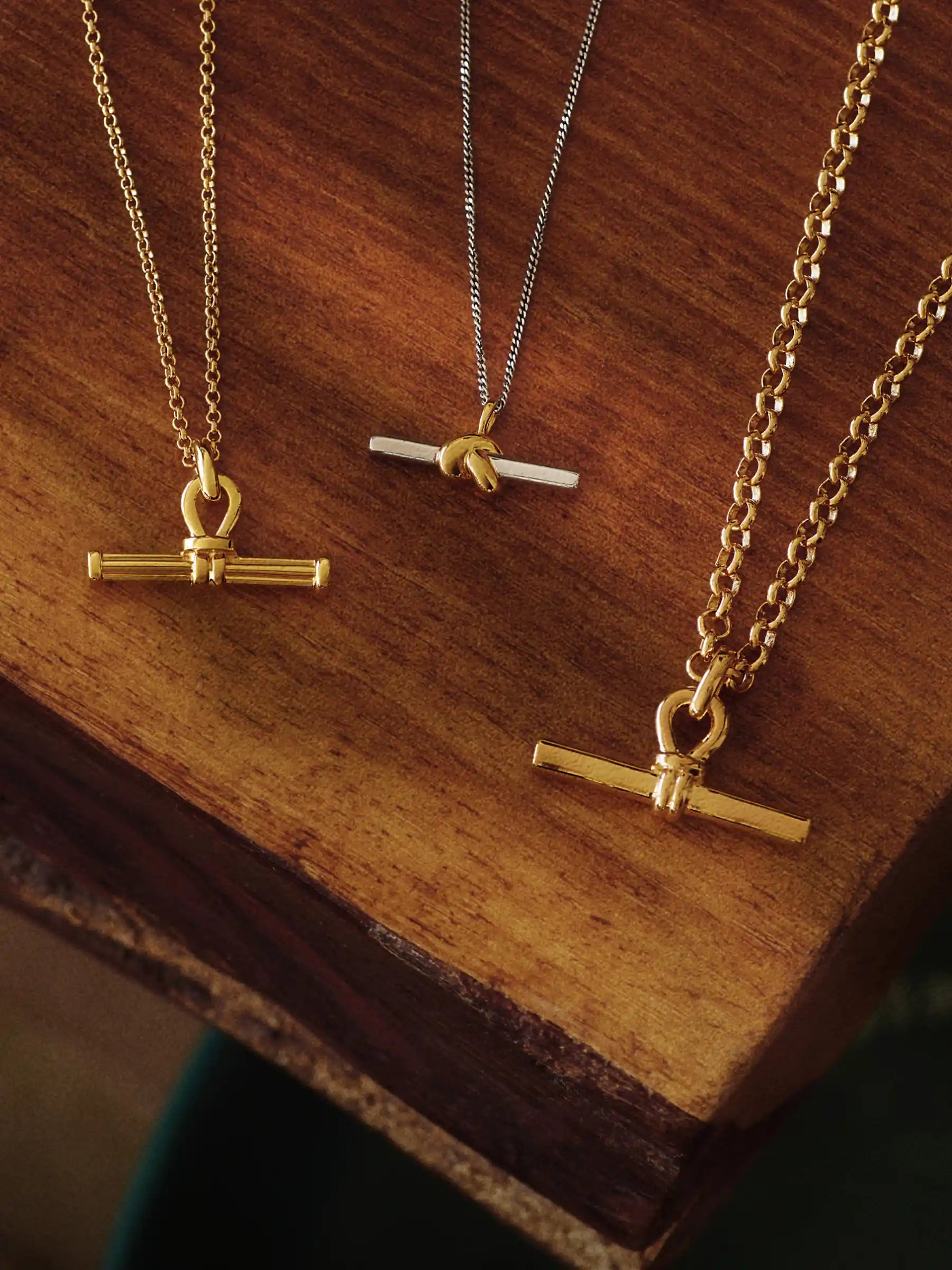 T Bar necklaces on a wooden table