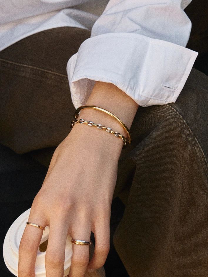 Gold bangle bracelet with mixed metal mariner bracelet