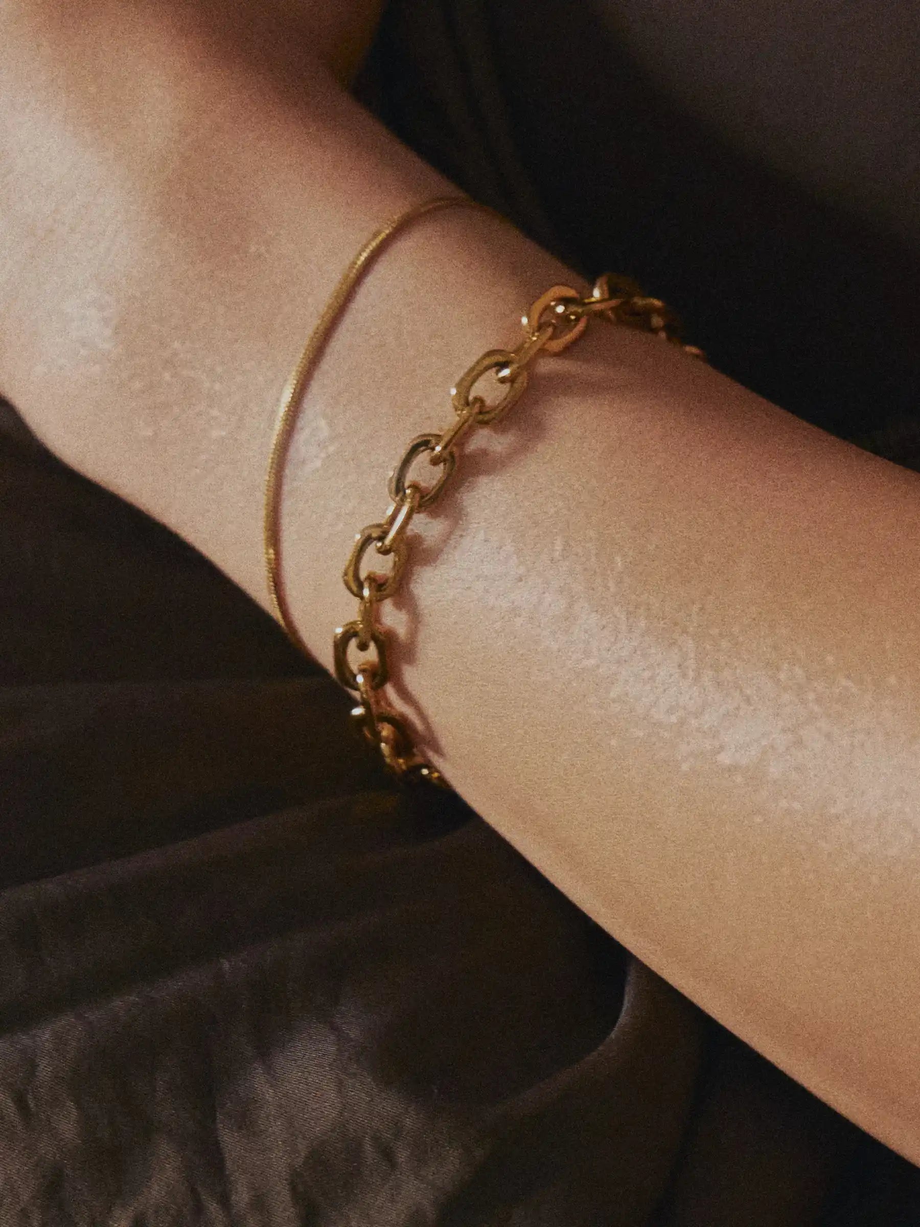 Gold chain bracelet on sweaty arm