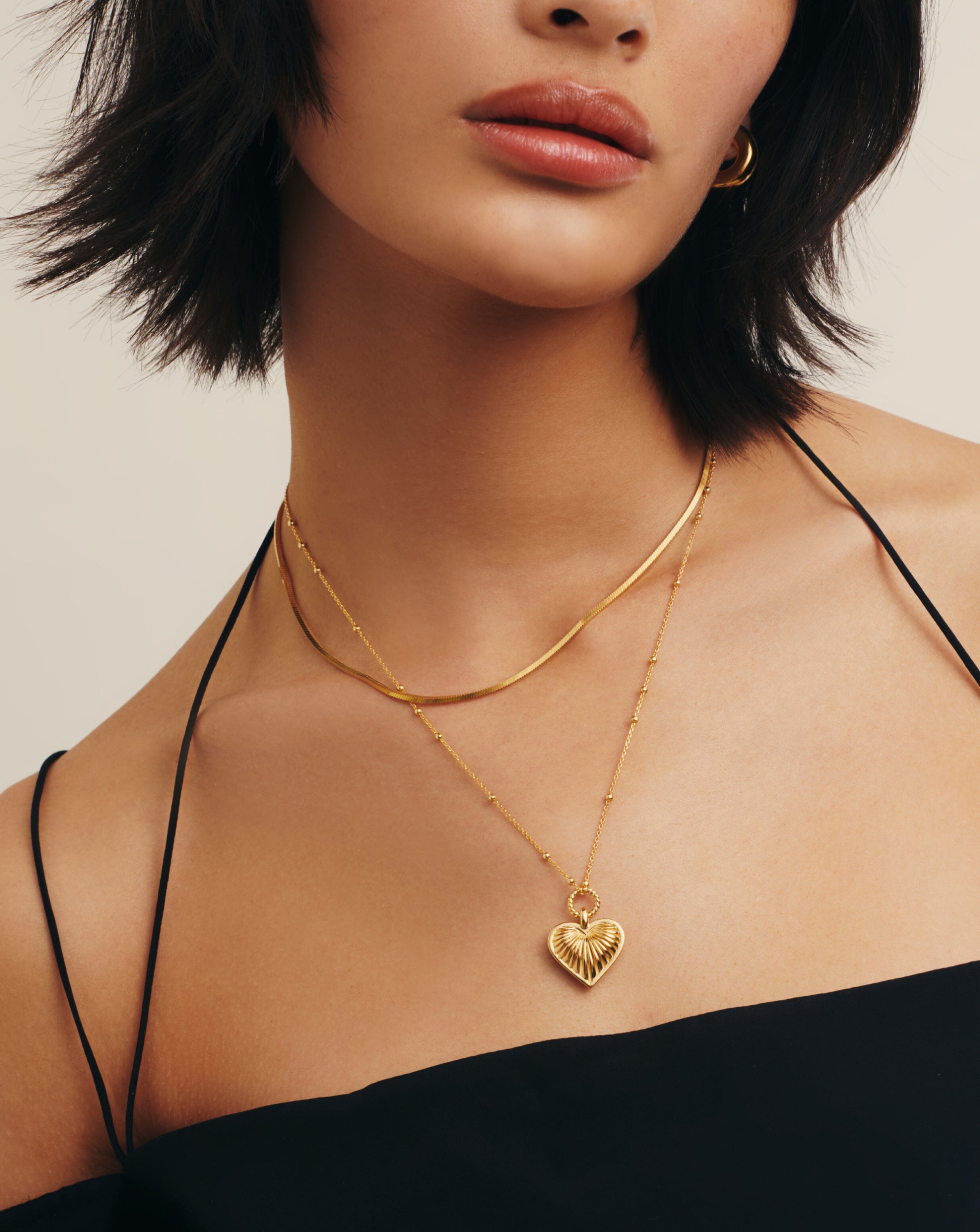 https://us.missoma.com/cdn/shop/files/ridge-heart-charm-pendant-necklace-18ct-gold-plated-necklaces-missoma-523432.jpg?v=1699589645&width=2472
